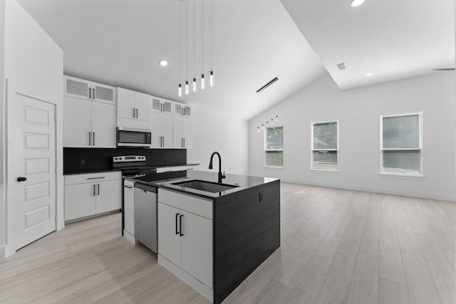 kitchen featuring sink, white cabinetry, pendant lighting, stainless steel appliances, and a kitchen island with sink