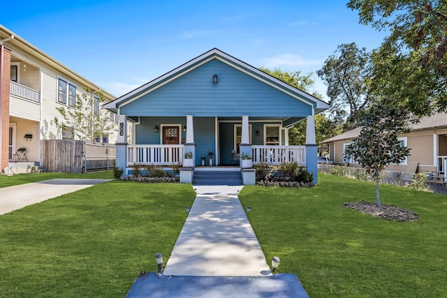 bungalow-style house with covered porch and a front yard