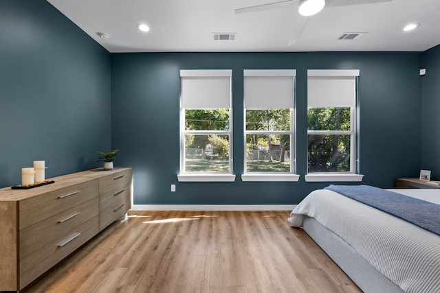 bedroom with ceiling fan and light hardwood / wood-style flooring