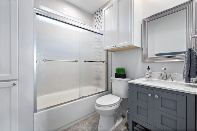 full bathroom featuring enclosed tub / shower combo, toilet, and vanity