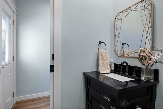 bathroom with hardwood / wood-style floors and vanity