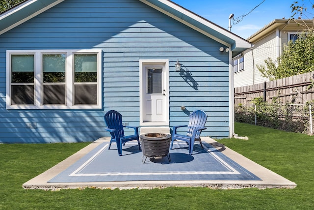 back of house with a patio, a yard, and an outdoor fire pit