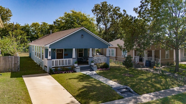 bungalow with a front lawn and covered porch