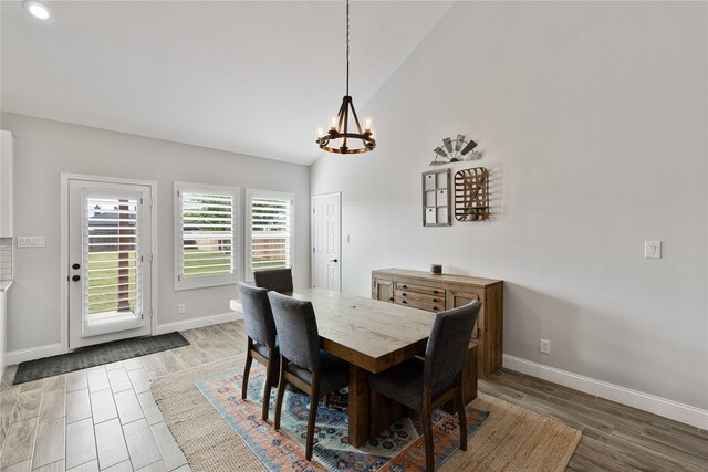 dining space featuring a chandelier and vaulted ceiling