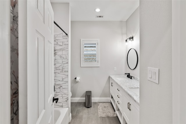 bathroom with vanity and washtub / shower combination