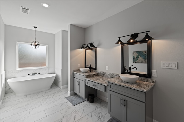 bathroom with vanity and a tub