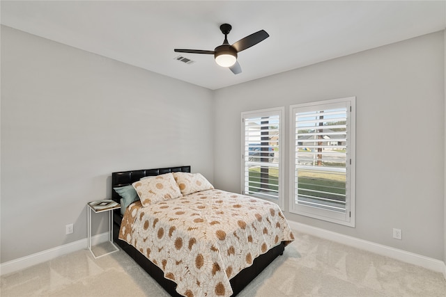 bedroom featuring ceiling fan and light carpet