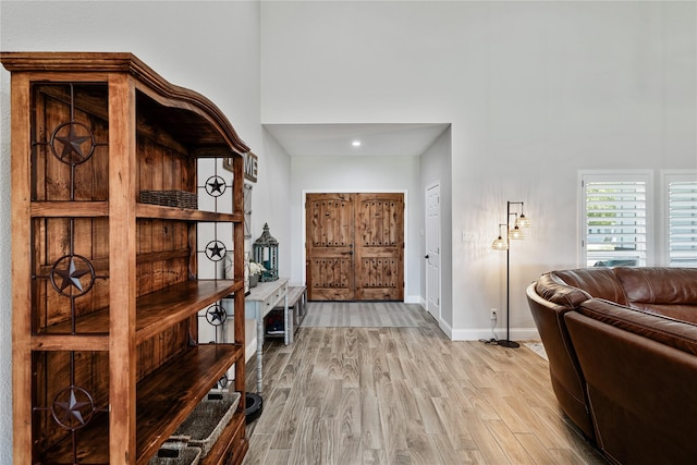 interior space with a high ceiling and light wood-type flooring