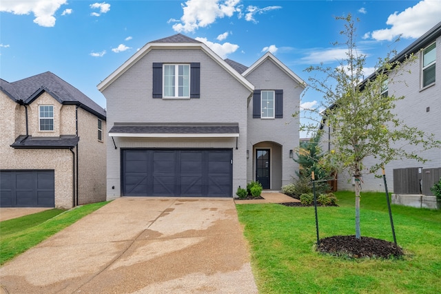 front of property featuring a garage and a front lawn