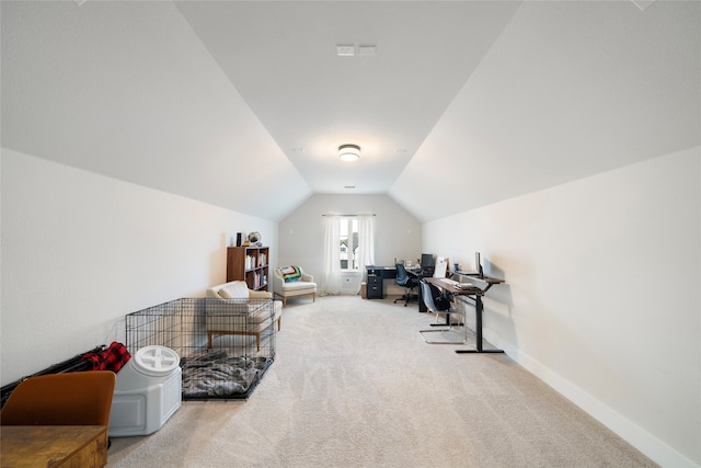 interior space with light carpet and vaulted ceiling