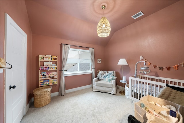 bedroom featuring carpet, a nursery area, and vaulted ceiling