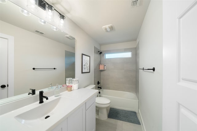 full bathroom featuring tile patterned flooring, vanity, tiled shower / bath combo, and toilet