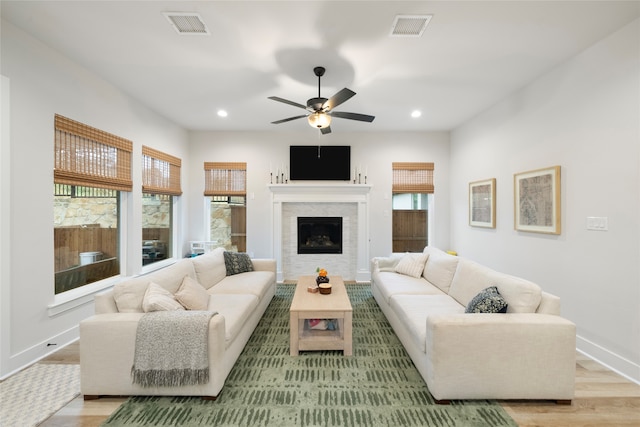 living room featuring ceiling fan, a healthy amount of sunlight, and light hardwood / wood-style flooring