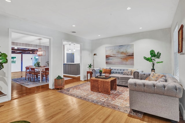 living room featuring a chandelier and hardwood / wood-style floors