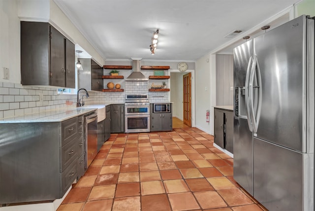 kitchen with crown molding, stainless steel appliances, light tile patterned floors, decorative backsplash, and wall chimney exhaust hood