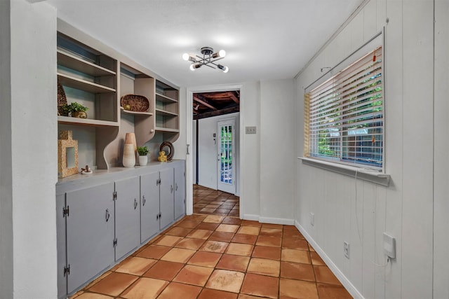 interior space featuring wooden walls, light tile patterned flooring, and a chandelier