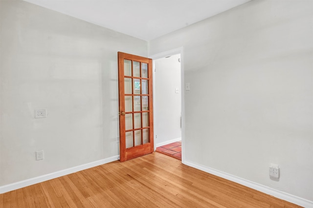 spare room with light hardwood / wood-style flooring