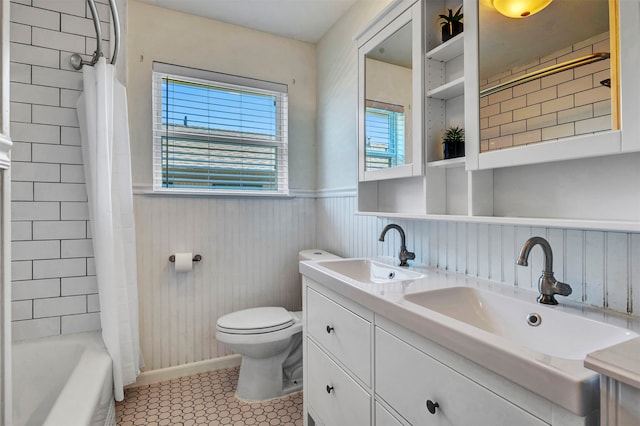 full bathroom featuring toilet, vanity, tile patterned floors, and shower / tub combo with curtain