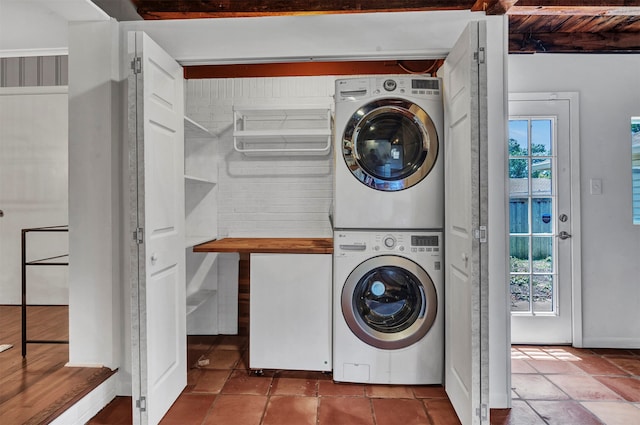 laundry room with stacked washer / dryer