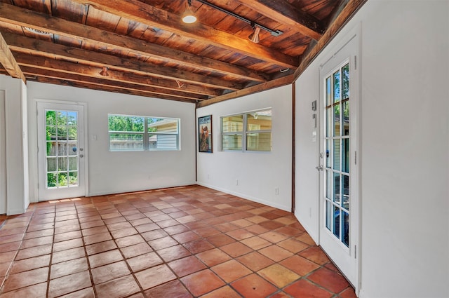 unfurnished sunroom with beamed ceiling and wood ceiling