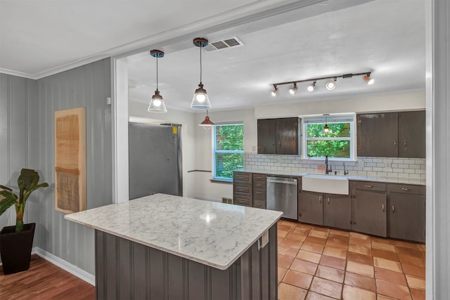 kitchen with decorative backsplash, dark brown cabinetry, and stainless steel dishwasher