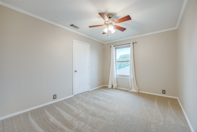 spare room featuring ceiling fan, light carpet, and crown molding