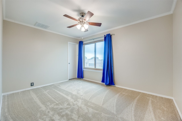 spare room with ornamental molding, light carpet, and ceiling fan