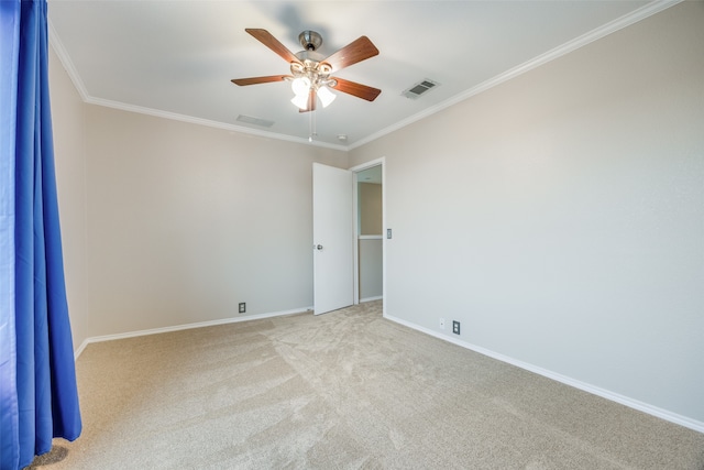 carpeted spare room with ornamental molding and ceiling fan