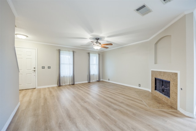 unfurnished living room with ornamental molding, a fireplace, light hardwood / wood-style flooring, and ceiling fan