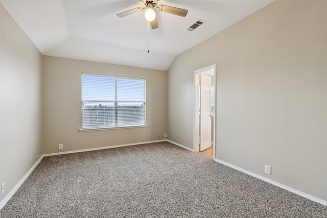 empty room featuring ceiling fan, light carpet, and vaulted ceiling