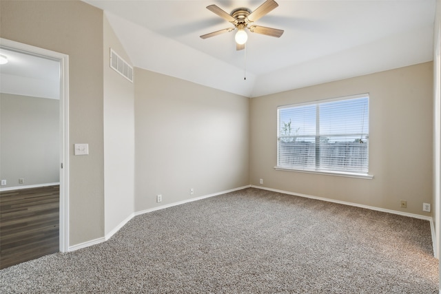 carpeted empty room with ceiling fan and lofted ceiling