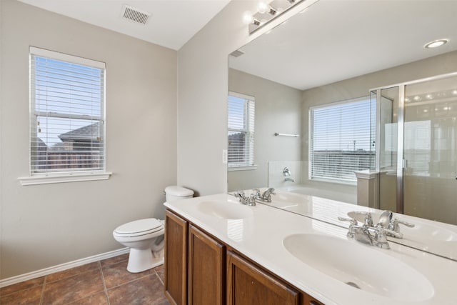 full bathroom featuring tile patterned flooring, vanity, shower with separate bathtub, and toilet