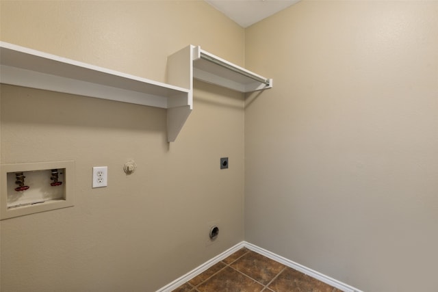 laundry area with electric dryer hookup, hookup for a gas dryer, hookup for a washing machine, and dark tile patterned floors