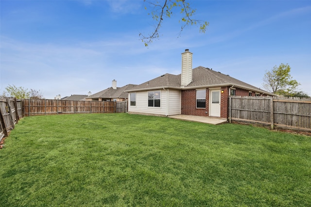 rear view of house featuring a patio area and a yard