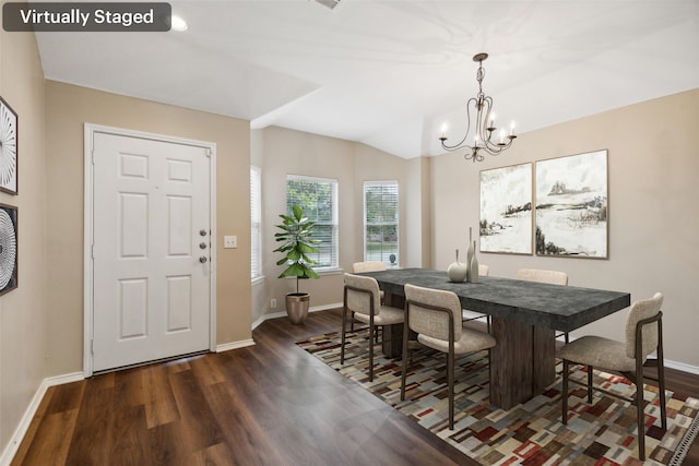 dining room with dark wood-type flooring, lofted ceiling, and a notable chandelier