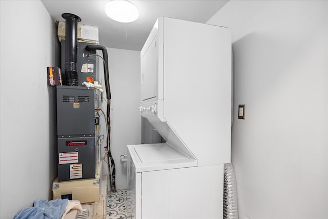 clothes washing area featuring stacked washer / dryer