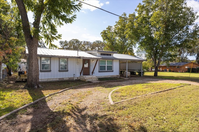 ranch-style house featuring a front yard and a carport