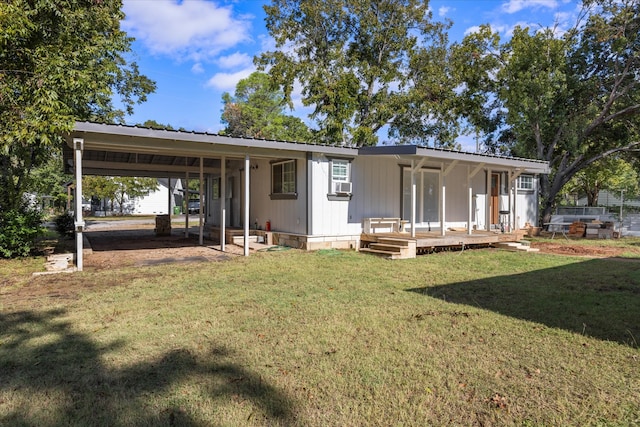 back of house with cooling unit, a deck, a yard, and a carport