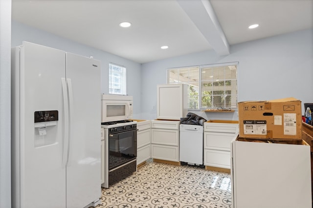 kitchen with white appliances, beamed ceiling, white cabinetry, and a wealth of natural light