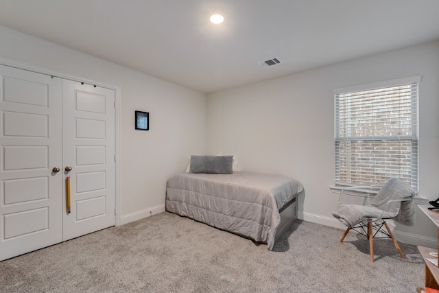 carpeted bedroom featuring a closet