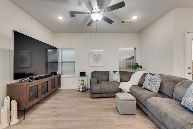 living room featuring light wood-type flooring and ceiling fan