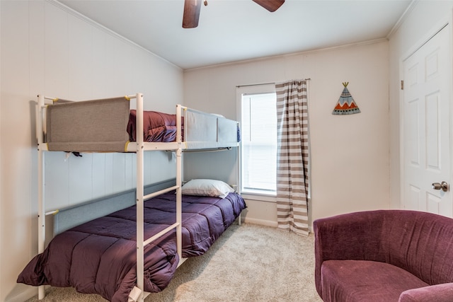 bedroom featuring ornamental molding, light colored carpet, and ceiling fan