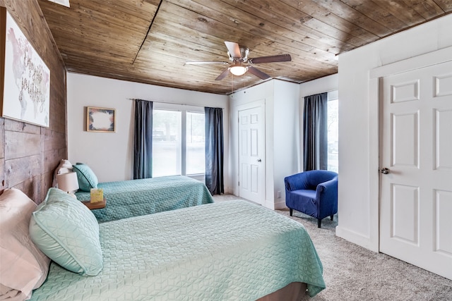 carpeted bedroom with ceiling fan and wood ceiling