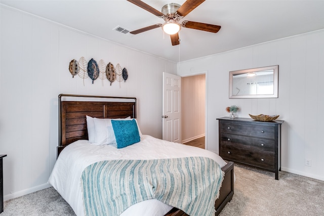 bedroom featuring ceiling fan, ornamental molding, and light colored carpet