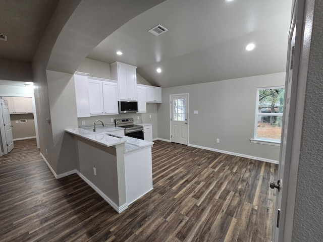 kitchen with stainless steel appliances, dark wood-type flooring, vaulted ceiling, kitchen peninsula, and white cabinetry