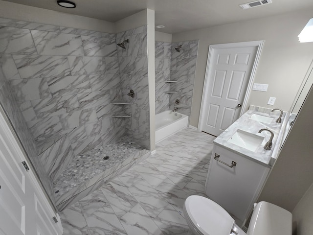 full bathroom featuring vanity, tiled shower / bath combo, and toilet