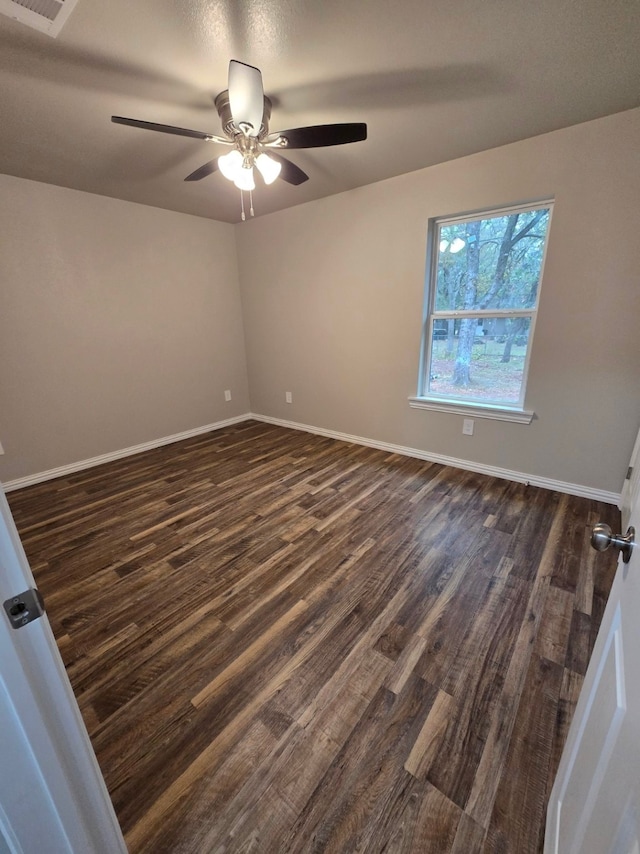 unfurnished room with ceiling fan and dark hardwood / wood-style floors