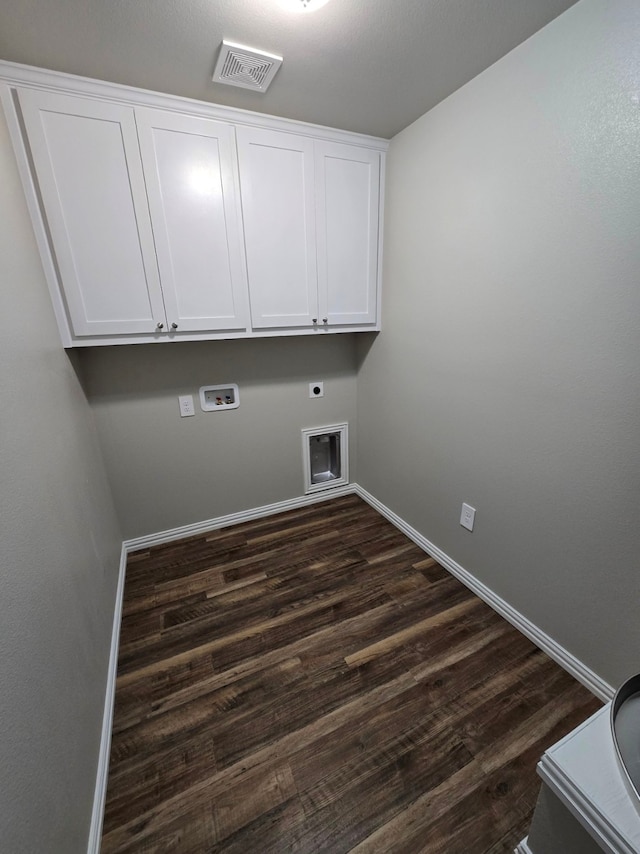 clothes washing area with dark wood-type flooring, cabinets, hookup for a washing machine, and electric dryer hookup