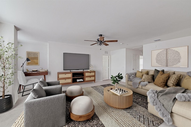 living room with ceiling fan and light colored carpet