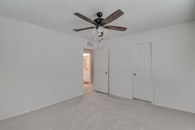 unfurnished bedroom featuring ceiling fan and light colored carpet